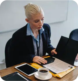 A Financial industry women reading a file and having a cup of black coffee. 